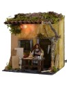 Carpintero en movimiento de 10 cm con casa iluminada Mondo Presepi