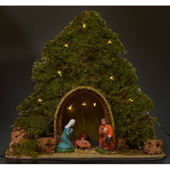 Tree with hut and Nativity illuminated with piled with