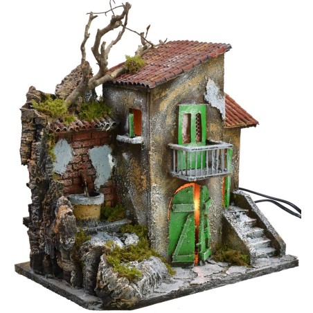 Casa iluminada con fuente funcionando de 30x21x35 cm h