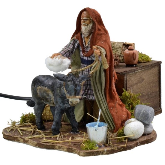 Man grooming donkey in motion 12 cm