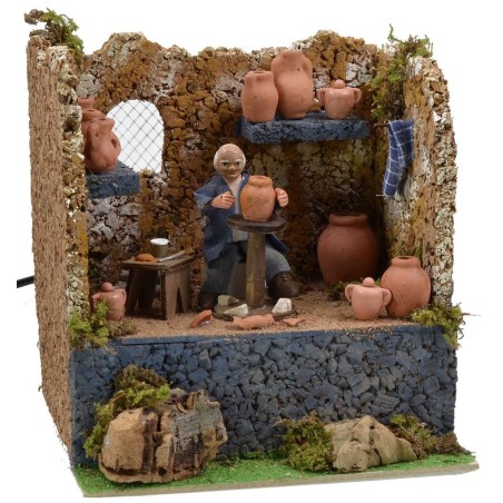 Alfarero sentado en movimiento serie 10 cm en el taller Mondo