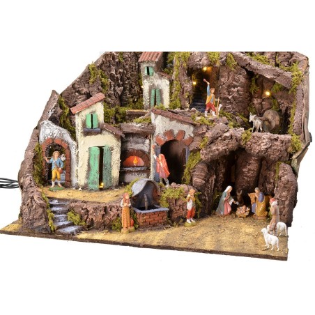 Illuminated nativity scene complete with Landi statues with fountain, fire