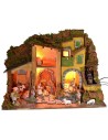 Illuminated nativity scene complete with Landi statues and water mill