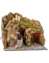 Paisaje iluminado con cueva y molino en funcionamiento a corriente