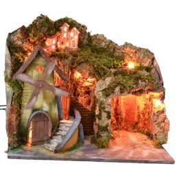 Paisaje iluminado con cueva y molino en funcionamiento a corriente