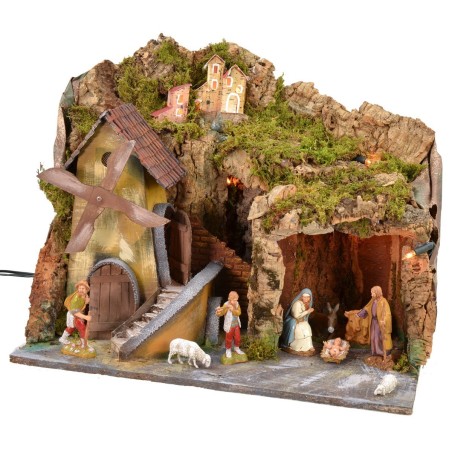 Classic illuminated nativity scene with grotto and mill running
