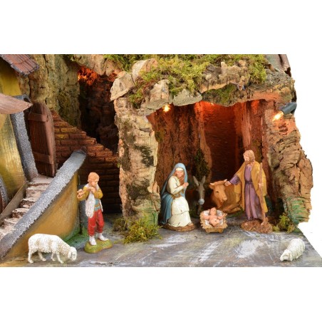 Classic illuminated nativity scene with grotto and mill running