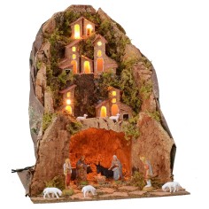 Classic illuminated nativity scene complete with statues with cave cm