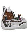Escenario de casa nevada con pista de patinaje que funciona con