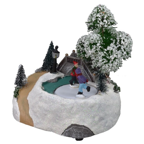 Christmas scenery with bridge and battery-operated skating rink
