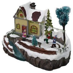 Escenario navideño con casa y pista de patinaje funcionando con