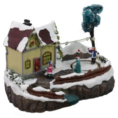 Escenario navideño con casa y pista de patinaje en funcionamiento. 2