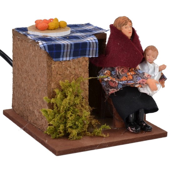 Donna seduta in movimento che culla il bimbo serie 12 cm Mondo