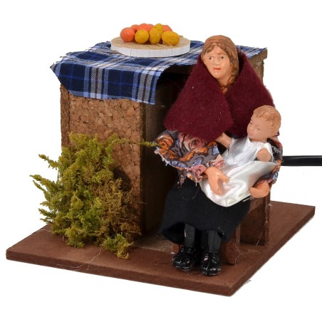 Mujer sentada en movimiento que acuna al niño serie 12 cm Mundo