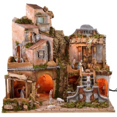 Belén iluminado con cascada funcionando, completo con estatuas.