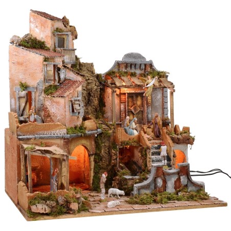 Belén iluminado con cascada funcionando, completo con estatuas.