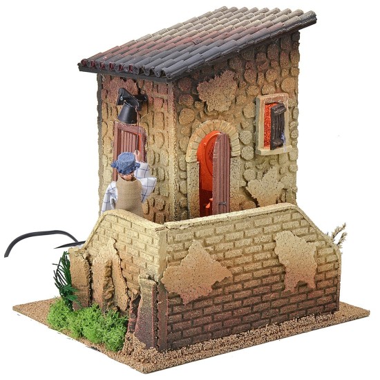 Illuminated double movement house with man playing the