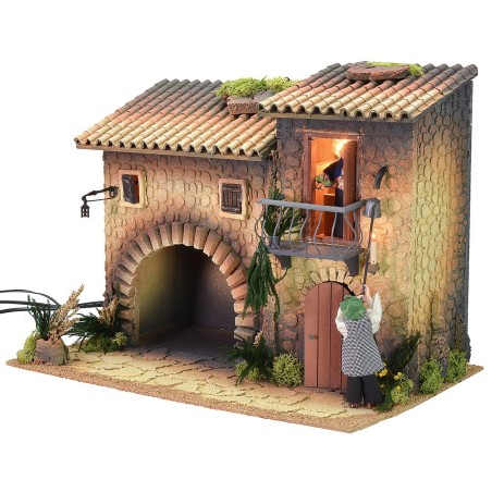 Illuminated house with moving lamplighter 12 cm and woman