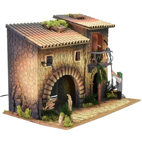 Illuminated house with moving lamplighter 12 cm and woman who