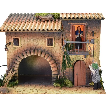 Illuminated house with moving lamplighter 12 cm and woman who