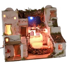 Illuminated Palestinian nativity scene with starry sky and oven