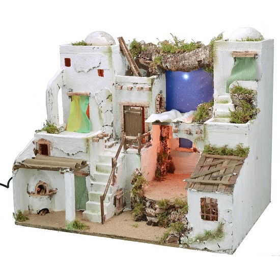 Illuminated Palestinian nativity scene with starry sky and oven