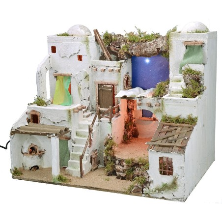Illuminated Palestinian nativity scene with starry sky and oven
