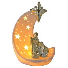 Natividad sobre la media luna en porcelana con luz de 17x10,3x24,5 cm.