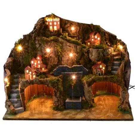 Illuminated nativity scene with functioning fountain and grotto