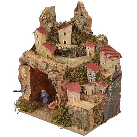 Pesebre iluminado con paisaje y cueva completa de Natividad.