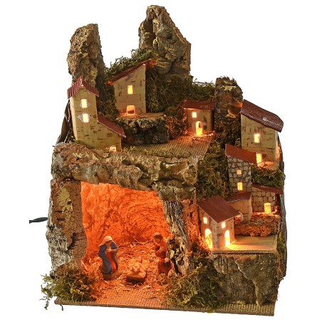 Presepe illuminato con paesaggio e grotta completa di Natività