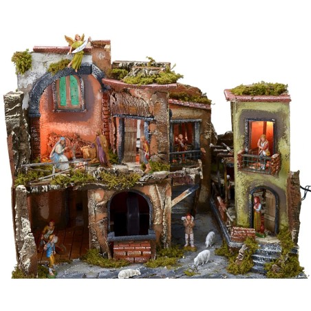 Nativity scene complete with statues with illuminated village, oven and