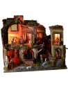 Nativity scene complete with statues with illuminated village, oven and