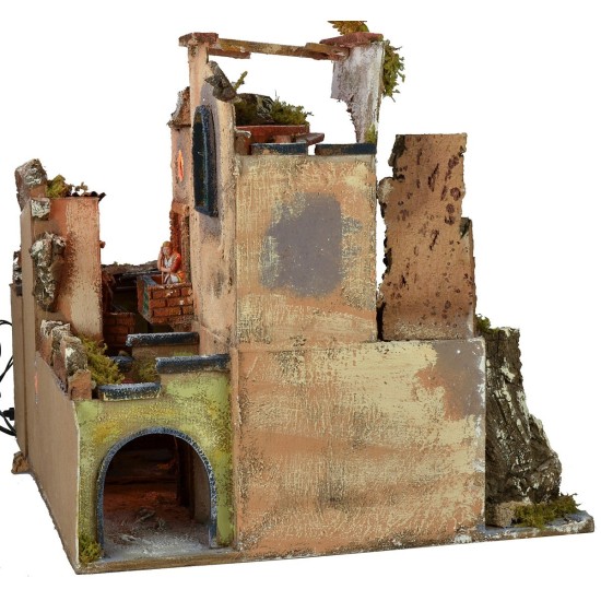 Complete nativity scene with statues, illuminated village, and oven