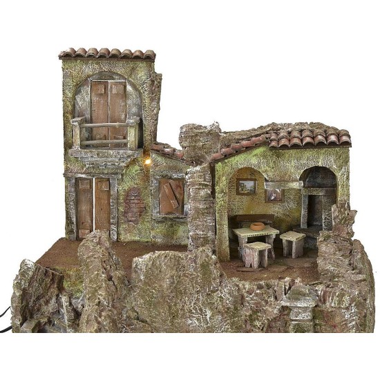 Pueblo iluminado con casa, taberna y fuente