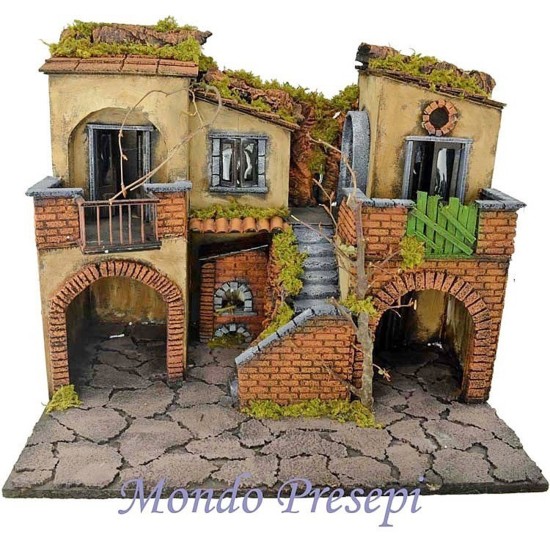 The crib with the village lit up with the oven 50x40