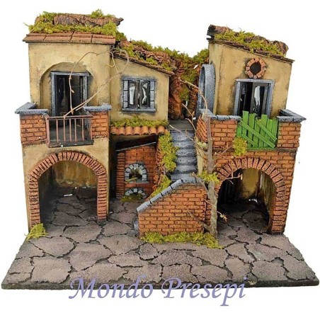 The crib with the village lit up with the oven 50x40