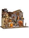 Illuminated nativity scene complete with Landi statues with village and cave
