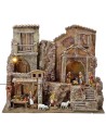 Illuminated nativity scene complete with Landi statues with houses and shops