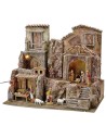 Illuminated nativity scene complete with Landi statues with houses and shops