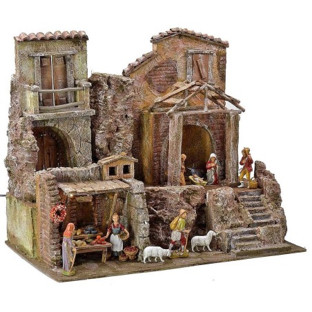 Illuminated nativity scene complete with Landi statues with houses and shops