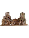 Illuminated nativity scene complete with Landi statues with houses and fountain