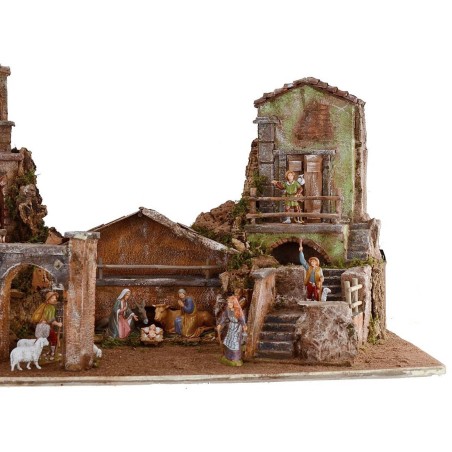 Illuminated nativity scene complete with Landi statues with houses and fountain