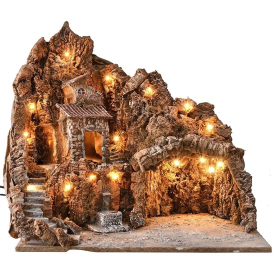 Pesebre iluminado con fuente funcionando y paisaje de