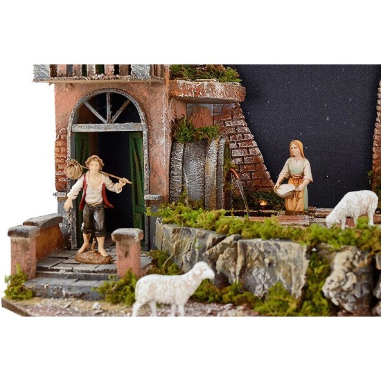 Pesebre completo de figuras Landi con cielo estrellado iluminado.