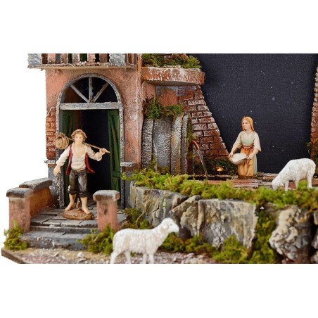 Pesebre completo de figuras Landi con cielo estrellado iluminado.