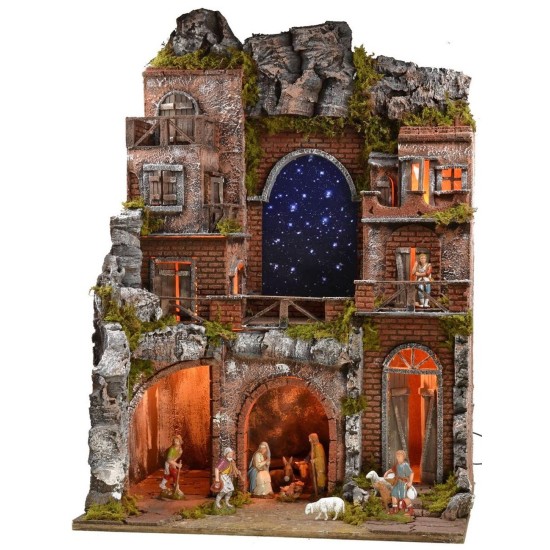 Belén iluminado completo con estatuas Landi y cielo estrellado.