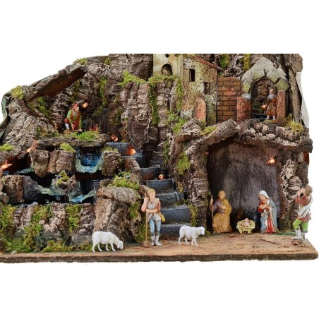 Illuminated nativity scene complete with Landi statues with fire and waterfall