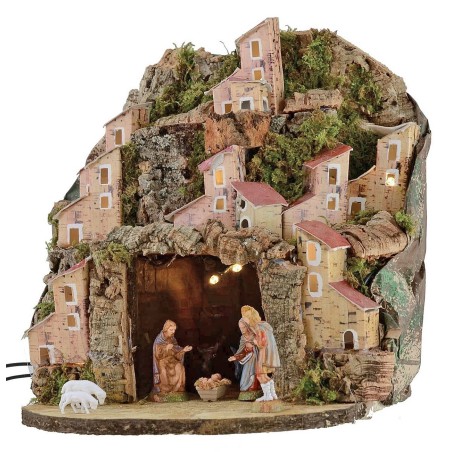 Illuminated nativity scene complete with Landi statues with village
