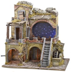 Belén iluminado con cielo estrellado de fibras ópticas y molino.